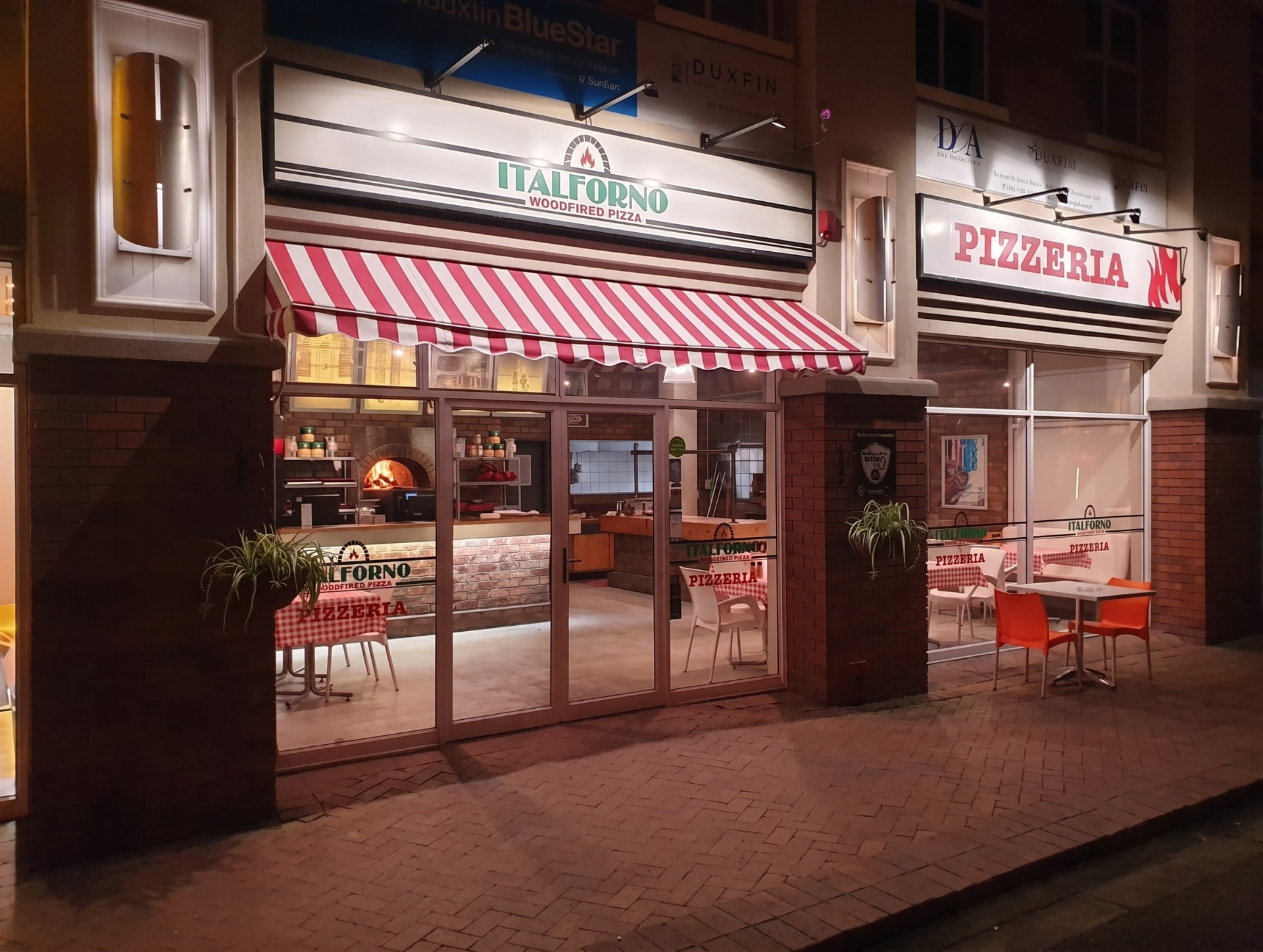 Italforno Pizzeria storefront on Wellington Road at night