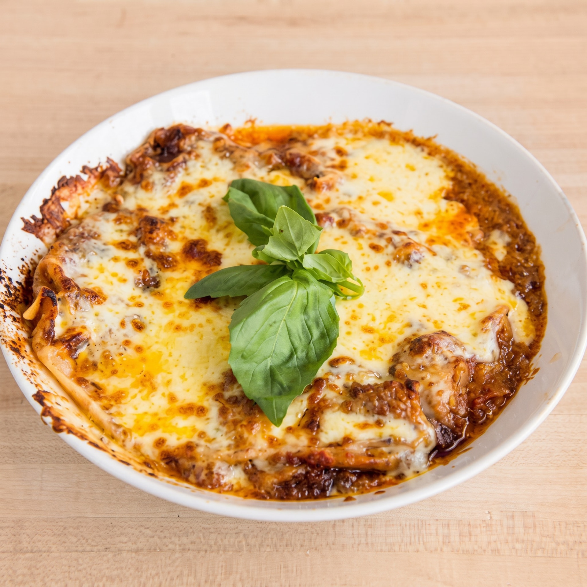 Baked lasagne with golden mozzarella and fresh basil at Italforno